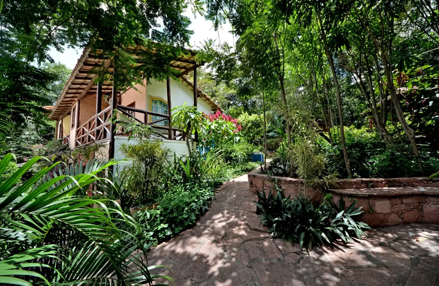 Shaded path through the gardens and accommodation buildings at Pousada Vila Serrano